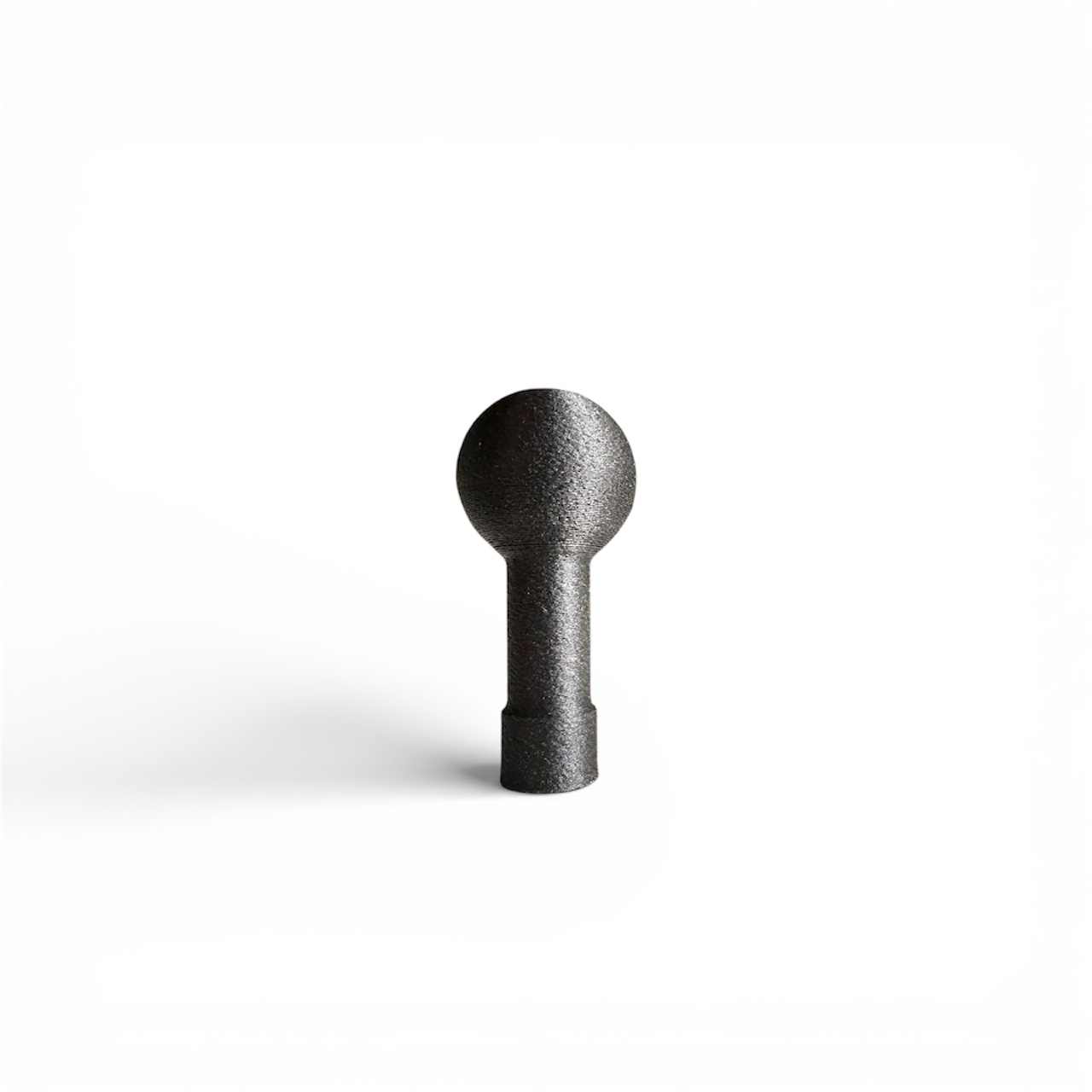 Universal M6 accessory mount installed inside car, metal ball mount fixed near window, interior vehicle accessory mounting point, compact dashboard mounting solution, universal car accessory bracket, phone and camera mount base, rugged in-car mounting hardware, modular vehicle mount system, close-up of accessory mount in car, universal threaded mount for automotive accessories