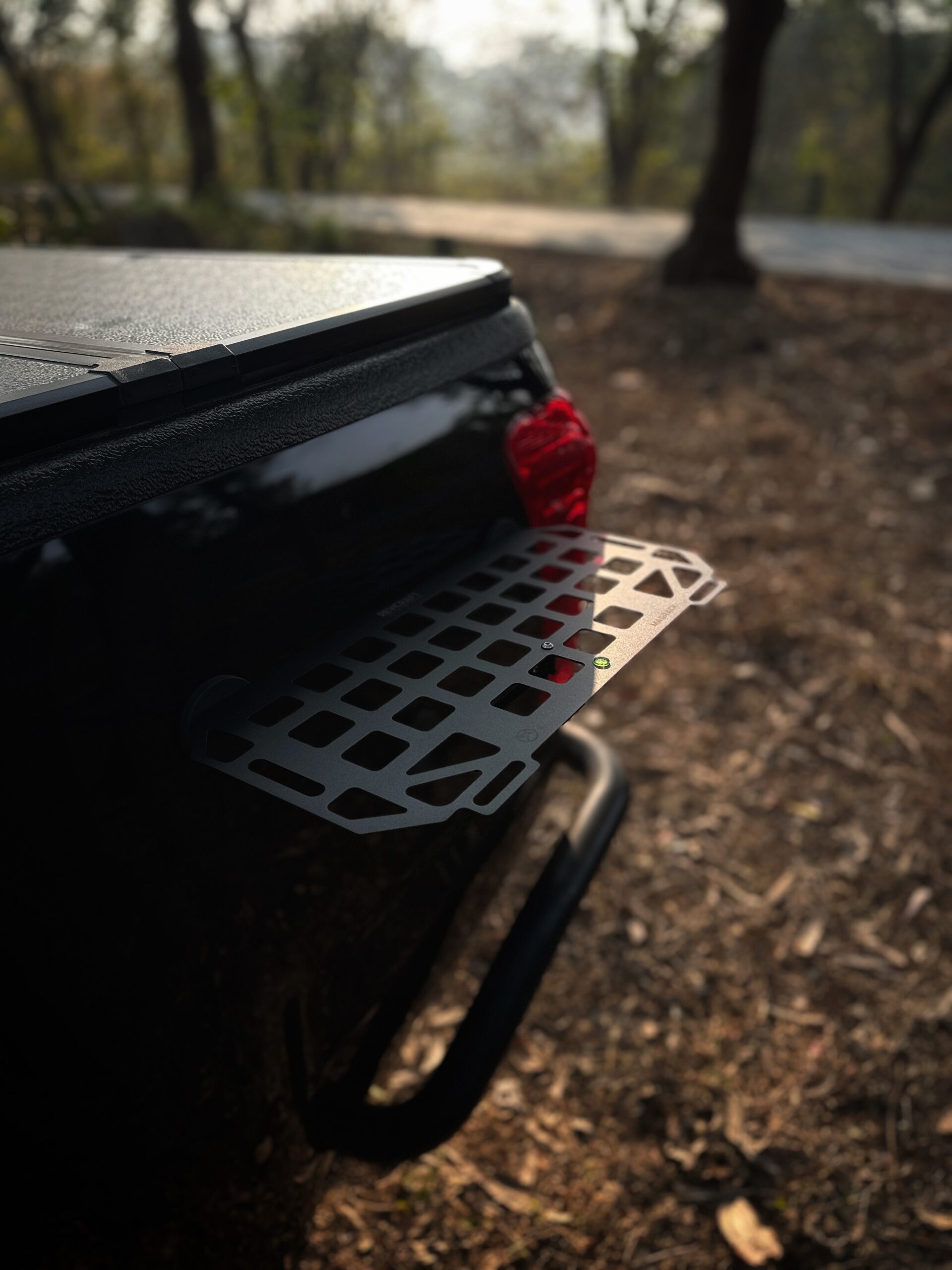 RevCraft MagRack magnetic outdoor tray mounted on a 4x4 steel surface, close-up of three rubber coated magnets on MagRack tray, RevCraft MagRack tray showing embedded spirit level, MagRack outdoor tray with cross bar support for stability, MagRack tray holding coffee cups and snacks during camping, RevCraft MagRack used as a cooking prep tray at an overlanding campsite, MagRack tray mounted on a 4x4 body panel during a roadside stop, RevCraft MagRack powder coated steel tray product close-up, MagRack tray load test with tools and gear, RevCraft MagRack tray packed inside protective carry bag, MagRack tray stored in vehicle trunk for travel, RevCraft MagRack magnetic tray mounted on a 4x4 tailgate, MagRack tray used for organizing recovery gear, RevCraft MagRack outdoor tray used for city dine-in setup, MagRack tray mounted on a steel roof rack side, close-up of MagRack cross bar and mounting structure, RevCraft MagRack tray holding camera gear safely, MagRack tray leveled using spirit level for hot drinks, RevCraft MagRack tray in overland setup with cookware, MagRack magnetic tray for 4x4 camping and outdoor use