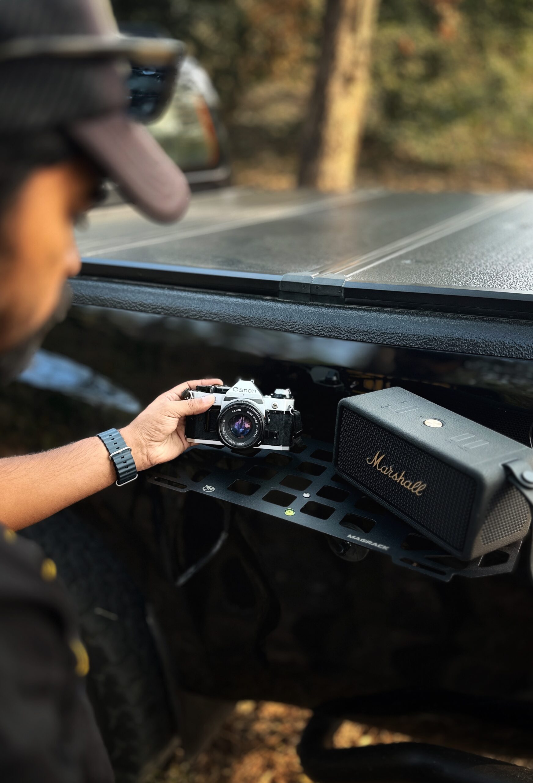RevCraft MagRack magnetic outdoor tray mounted on a 4x4 steel surface, close-up of three rubber coated magnets on MagRack tray, RevCraft MagRack tray showing embedded spirit level, MagRack outdoor tray with cross bar support for stability, MagRack tray holding coffee cups and snacks during camping, RevCraft MagRack used as a cooking prep tray at an overlanding campsite, MagRack tray mounted on a 4x4 body panel during a roadside stop, RevCraft MagRack powder coated steel tray product close-up, MagRack tray load test with tools and gear, RevCraft MagRack tray packed inside protective carry bag, MagRack tray stored in vehicle trunk for travel, RevCraft MagRack magnetic tray mounted on a 4x4 tailgate, MagRack tray used for organizing recovery gear, RevCraft MagRack outdoor tray used for city dine-in setup, MagRack tray mounted on a steel roof rack side, close-up of MagRack cross bar and mounting structure, RevCraft MagRack tray holding camera gear safely, MagRack tray leveled using spirit level for hot drinks, RevCraft MagRack tray in overland setup with cookware, MagRack magnetic tray for 4x4 camping and outdoor use