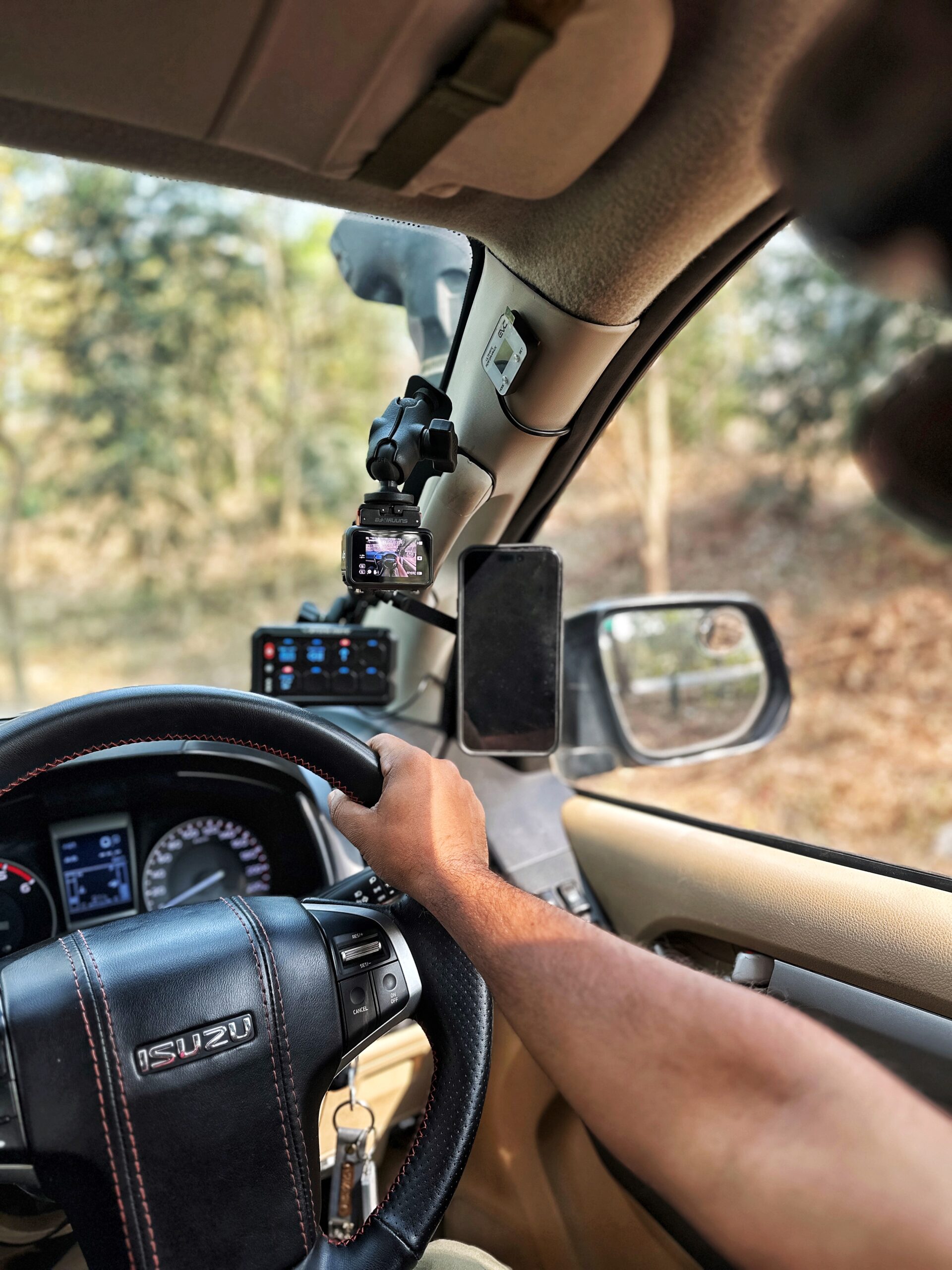 RevCraft A-Pillar Mount bracket with triple 1-inch ball base installed inside 4x4 cabin, Modular A-pillar mounting bracket with 3 one-inch ball mounts, 4x4 A-pillar accessory mount with universal 1-inch ball system, RevCraft A-Pillar Mount installed on vehicle A-pillar with modular ball mounts, Cabin A-pillar bracket holding 1-inch ball mounting system, Interior A-pillar mount setup for phone walkie and camera modules, Close-up of RevCraft A-Pillar bracket with three 1-inch ball mounts, Textured metal A-pillar mounting bracket with ball system, Modular A-pillar mount base with universal ball joints, A-pillar mount holding action camera inside off-road vehicle, Modular cabin mount supporting phone and camera on A-pillar, 4x4 interior A-pillar mounting system in use