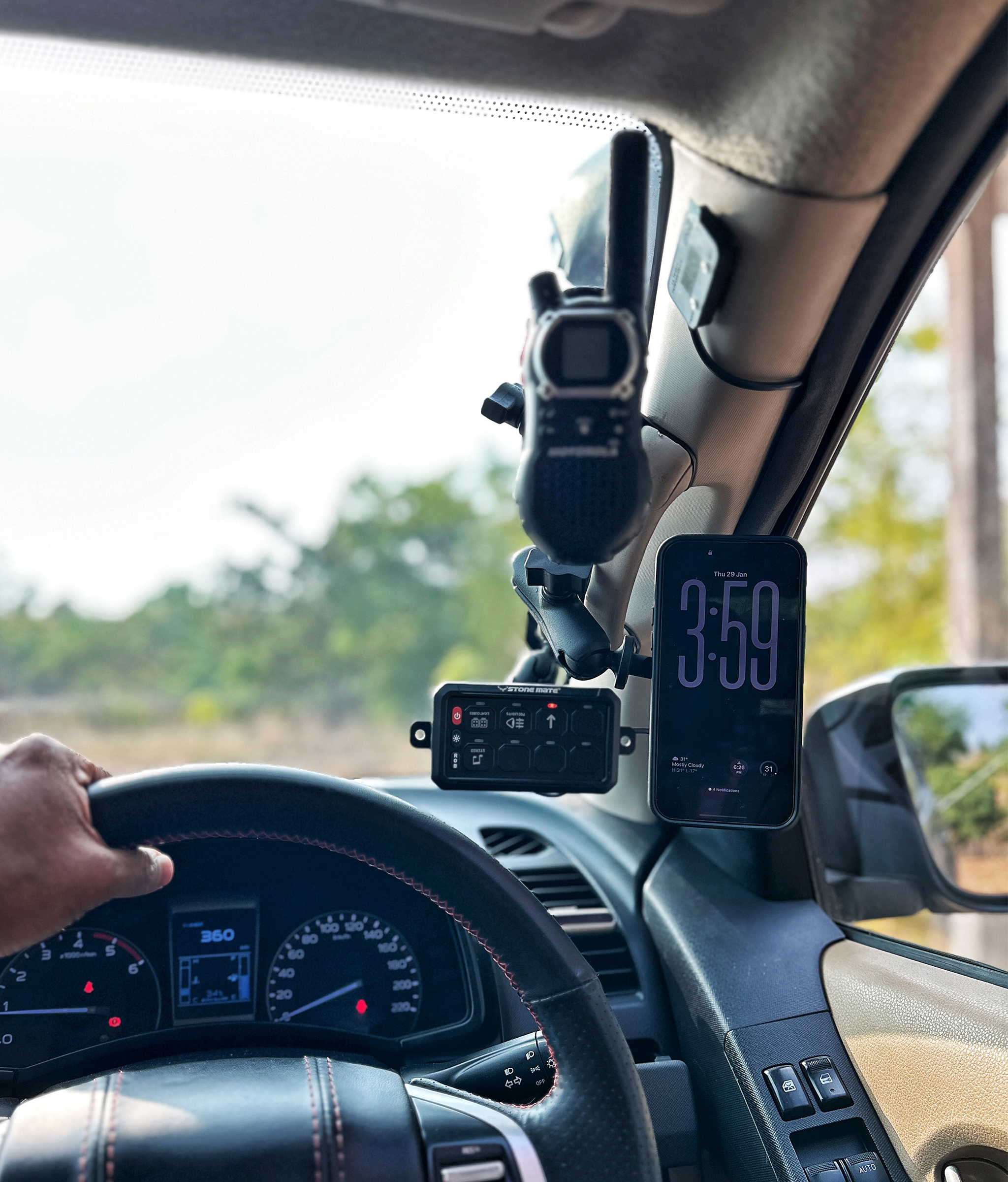 RevCraft A-Pillar Mount bracket with triple 1-inch ball base installed inside 4x4 cabin, Modular A-pillar mounting bracket with 3 one-inch ball mounts, 4x4 A-pillar accessory mount with universal 1-inch ball system, RevCraft A-Pillar Mount installed on vehicle A-pillar with modular ball mounts, Cabin A-pillar bracket holding 1-inch ball mounting system, Interior A-pillar mount setup for phone walkie and camera modules, Close-up of RevCraft A-Pillar bracket with three 1-inch ball mounts, Textured metal A-pillar mounting bracket with ball system, Modular A-pillar mount base with universal ball joints, A-pillar mount holding action camera inside off-road vehicle, Modular cabin mount supporting phone and camera on A-pillar, 4x4 interior A-pillar mounting system in use