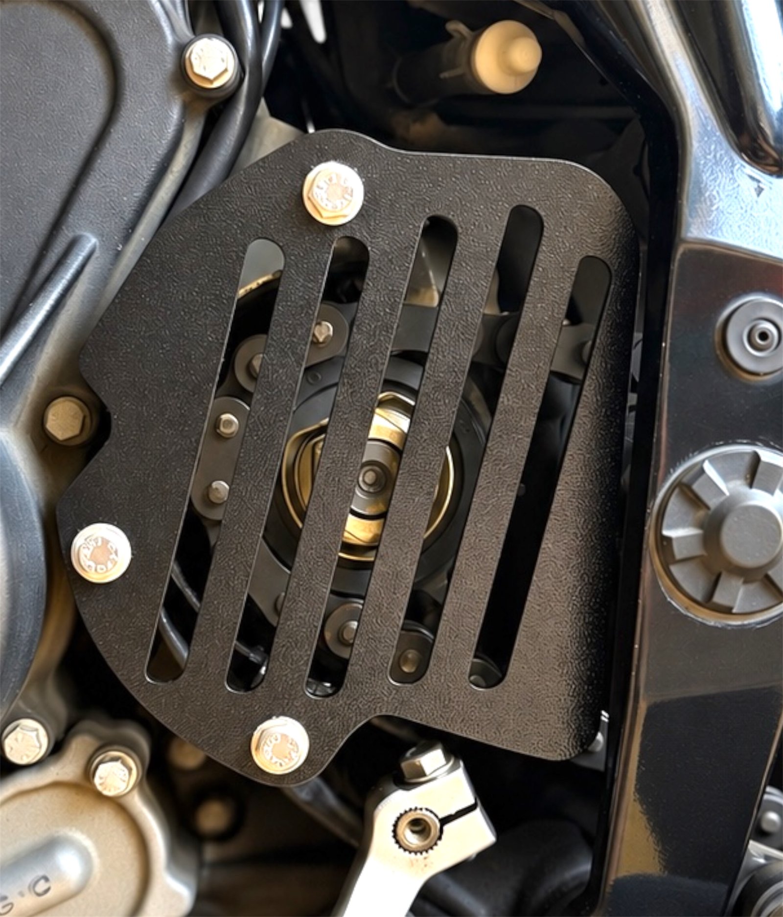 RevCraft KTM 390 Adventure heel guard set featuring precision laser-cut black metal construction with lightweight slotted design and OEM-style fitment